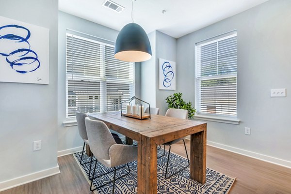 Dining room featuring elegant table setting and modern lighting at Alta Croft Apartments, luxury living spaces in a welcoming environment