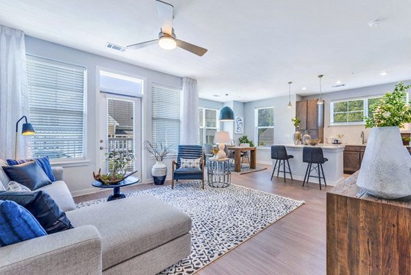 Spacious living room with elegant furnishings and natural light at Alta Croft Apartments