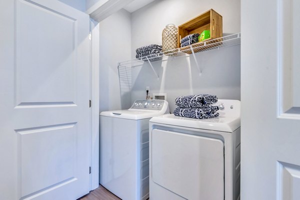 Laundry room with modern appliances at Alta Croft Apartments, a Greystar luxury community
