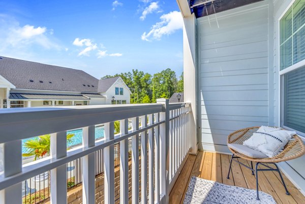 Cozy balcony with seating and lush views at Alta Croft Apartments, perfect for enjoying outdoor relaxation moments