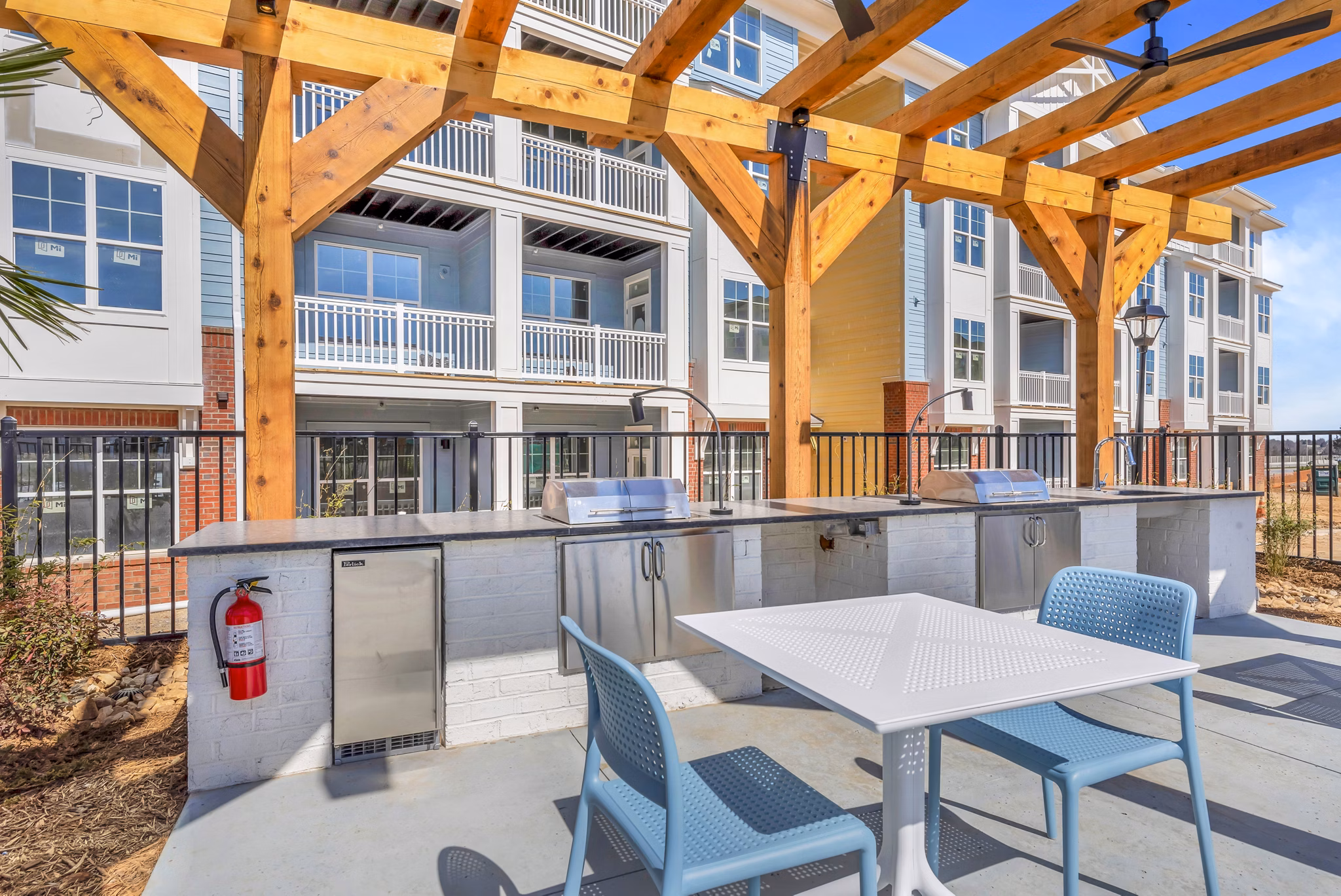 Grill area with seating on the patio at Alta Croft Apartments, perfect for outdoor gatherings and relaxation