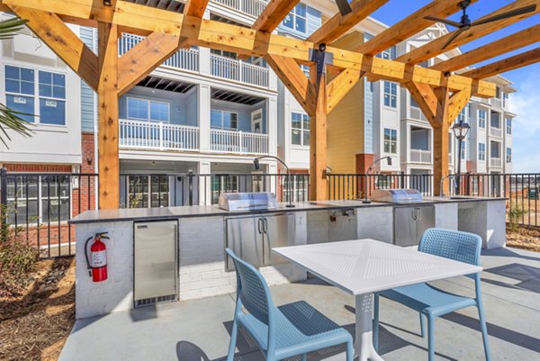 Grill area with seating on the patio at Alta Croft Apartments, perfect for outdoor gatherings and relaxation