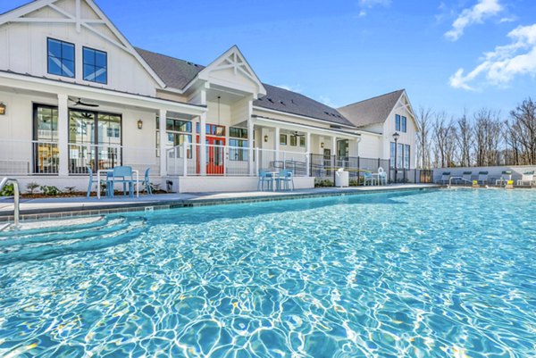 Luxurious poolside lounge at Alta Croft Apartments, featuring a shimmering pool with stylish seating, ideal for relaxation and social gatherings