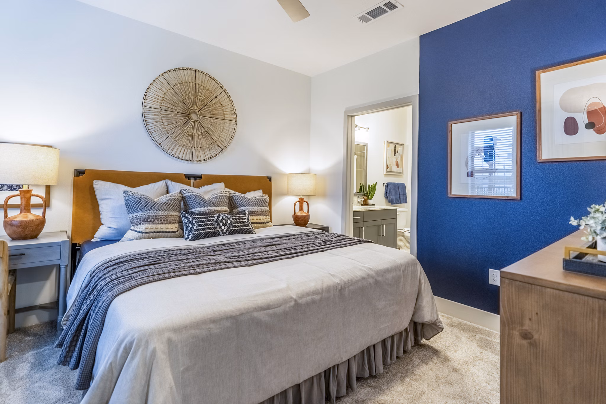 Bedroom with modern furnishings at Alta Cypress Springs Apartments, featuring a cozy bed and stylish decor