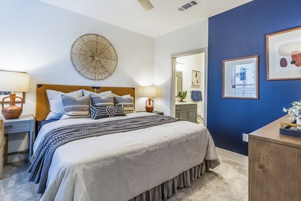 Bedroom with modern furnishings at Alta Cypress Springs Apartments, featuring a cozy bed and stylish decor