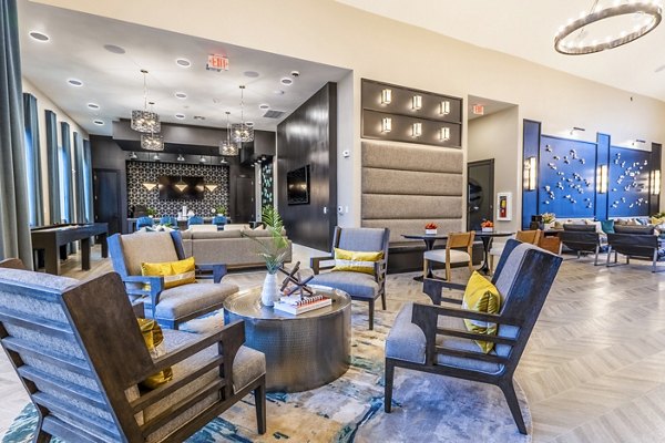 Clubhouse featuring modern decor and seating at Alta Cypress Springs Apartments, ideal for social gatherings and community events
