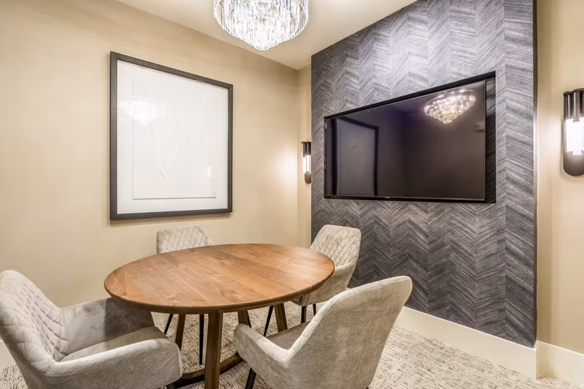 Meeting room with modern seating and tech amenities at Alta Cypress Springs Apartments, ideal for gatherings and professional events