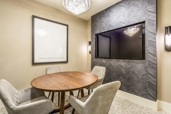Meeting room with modern seating and tech amenities at Alta Cypress Springs Apartments, ideal for gatherings and professional events
