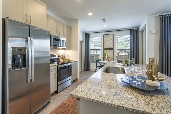 Alta Cypress Springs Apartments: Modern kitchen featuring stainless steel appliances and granite countertops
