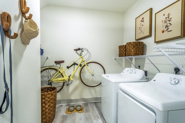 Laundry room with modern appliances at Alta Cypress Springs Apartments, offering premier amenities for convenient living