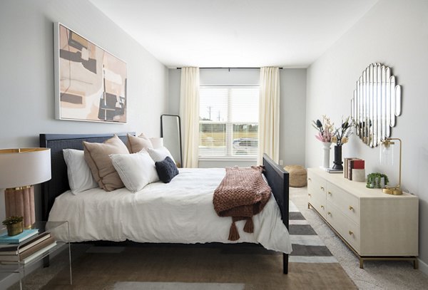 Cozy bedroom with stylish decor and ample natural light at Alta Davis Apartments