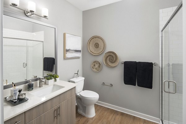 Modern bathroom with marble countertops and sleek fixtures at Alta Davis Apartments