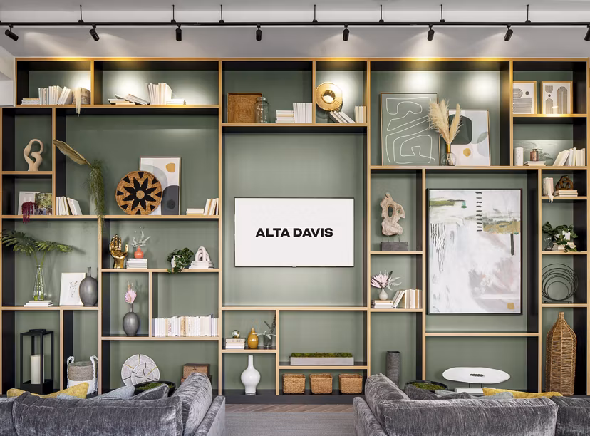 Modern clubhouse with lounge seating at Alta Davis Apartments, featuring vibrant decor and community gathering spaces