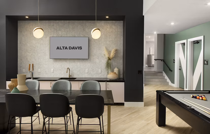 Modern clubhouse with cozy seating and vibrant decor at Alta Davis Apartments, ideal for social gatherings and relaxation