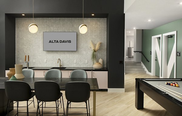 Modern clubhouse with cozy seating and vibrant decor at Alta Davis Apartments, ideal for social gatherings and relaxation