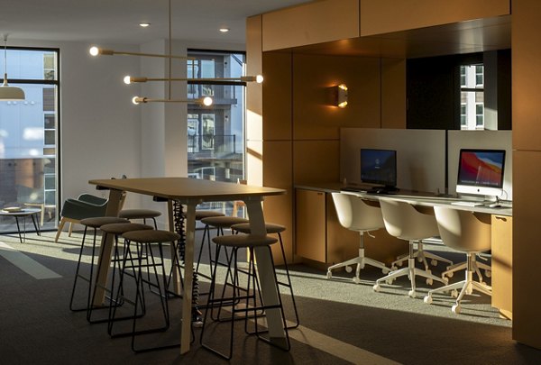 Modern business center with sleek workstations at Alta Davis Apartments in Morrisville, perfect for productivity and collaboration