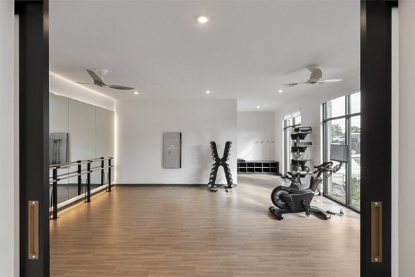 Modern fitness center with advanced equipment at Alta Davis Apartments
