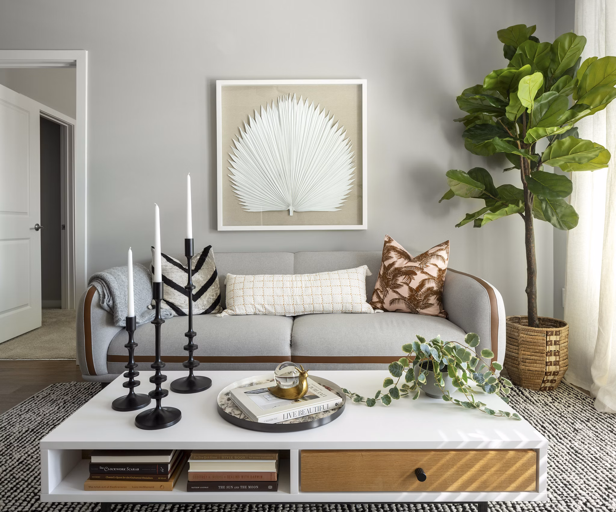 Modern living room with stylish decor at Alta Davis Apartments, featuring plush seating and large windows
