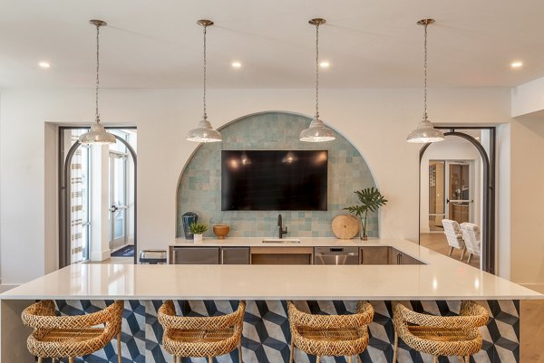 Clubhouse with modern decor and seating at Alta Deco Apartments