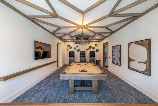 Modern clubhouse featuring stylish furnishings and entertainment space at Alta Deco Apartments, luxury living in a prime location