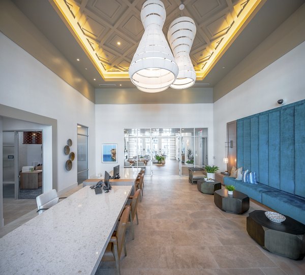 Chic clubhouse with modern decor at Alta Deco Apartments, perfect for socializing and events in a luxurious setting