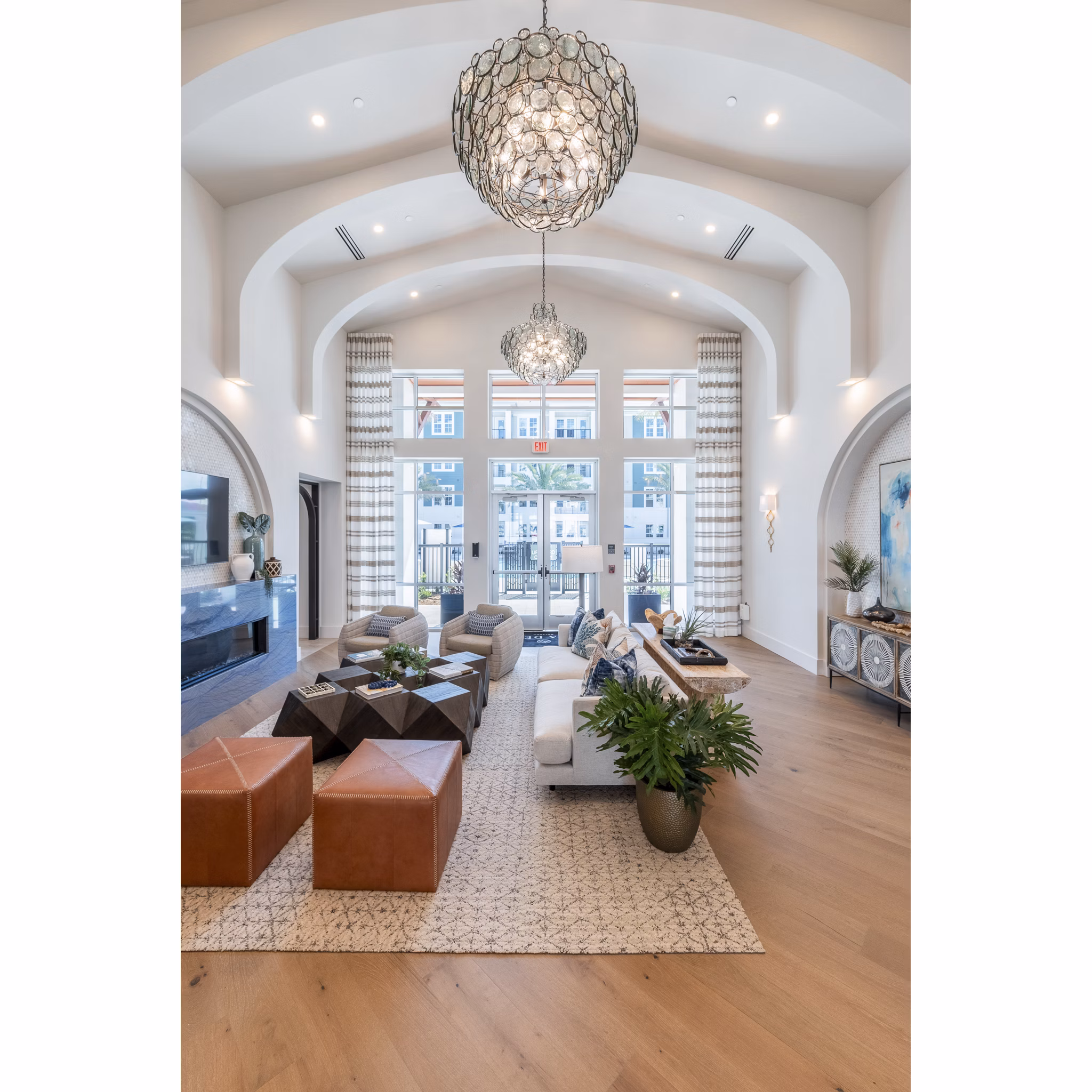 Clubhouse with modern decor and seating areas at Alta Deco Apartments