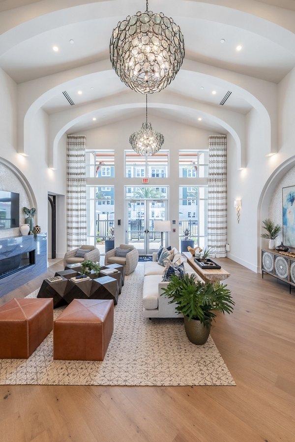 Clubhouse with modern decor and seating areas at Alta Deco Apartments