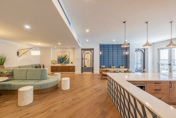 Alta Deco Apartments: Stylish clubhouse featuring modern design and cozy seating areas in a luxury community