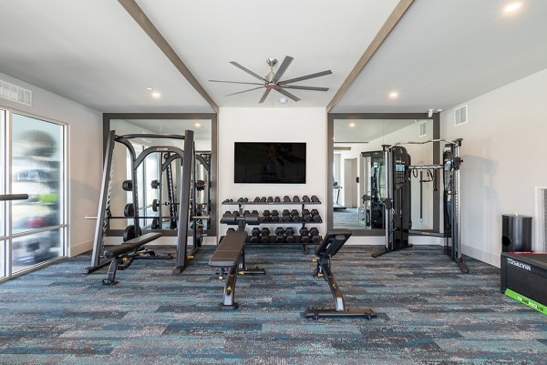 State-of-the-art fitness center featuring modern equipment at Alta Deco Apartments