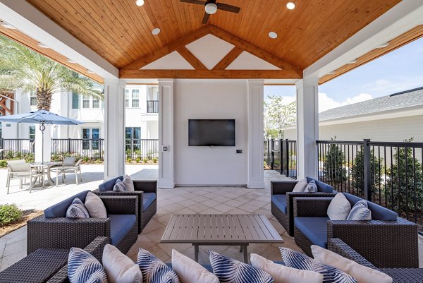 Spacious recreation area with modern design at Alta Deco Apartments, featuring open seating and vibrant decor for community gatherings