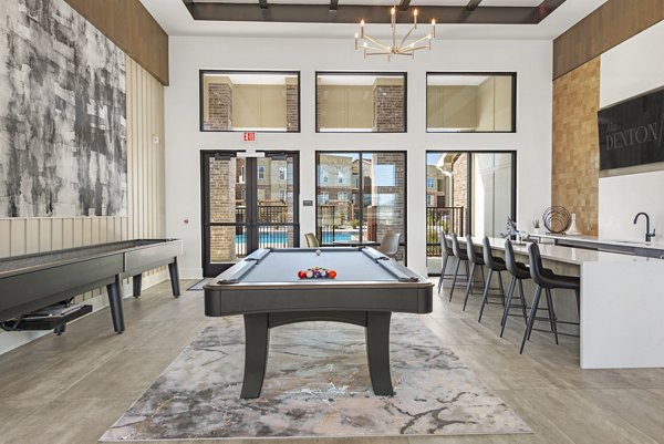 Clubhouse featuring modern design and cozy seating at Alta Denton Station Apartments