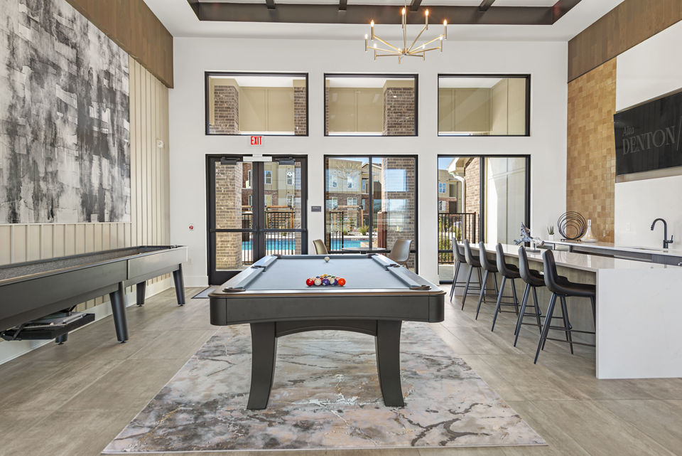 Clubhouse featuring modern design and cozy seating at Alta Denton Station Apartments