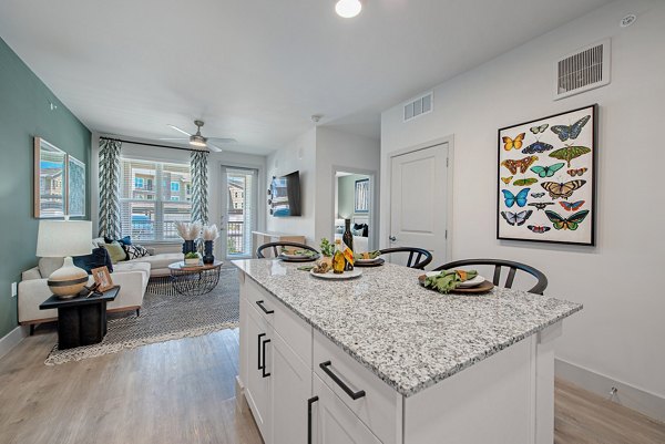 Dining area with modern decor and seating at Alta Denton Station Apartments, featuring luxury living spaces in a prime location