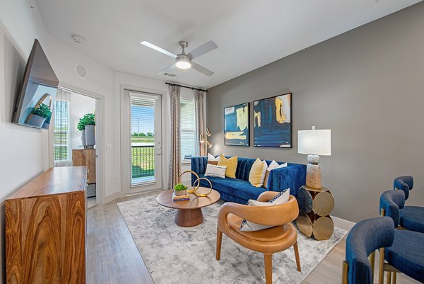 Spacious living room with modern decor and natural light in Alta Denton Station Apartments