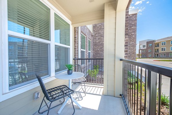 Outdoor patio with modern seating area at Alta Denton Station Apartments