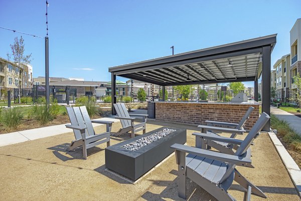 Recreation room with pool tables and lounge chairs at Alta Denton Station Apartments, perfect for social gatherings and relaxation