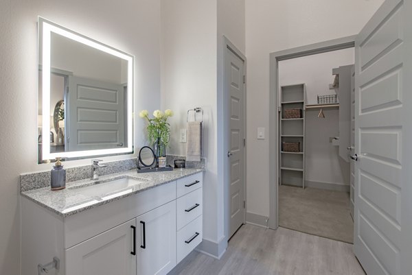Alta at the Farm Apartments: Modern bathroom with sleek fixtures and granite countertops