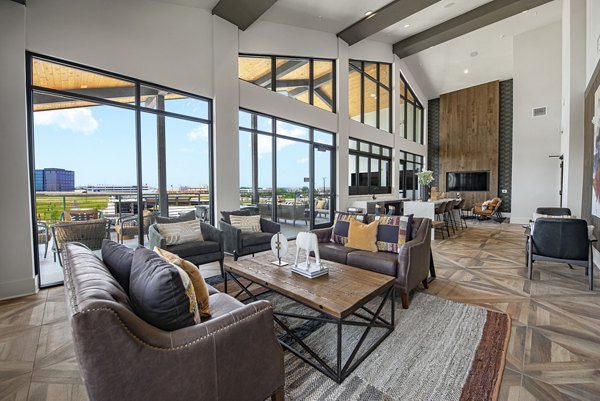 Clubhouse featuring modern design and communal seating at Alta at the Farm Apartments, a luxury Greystar community