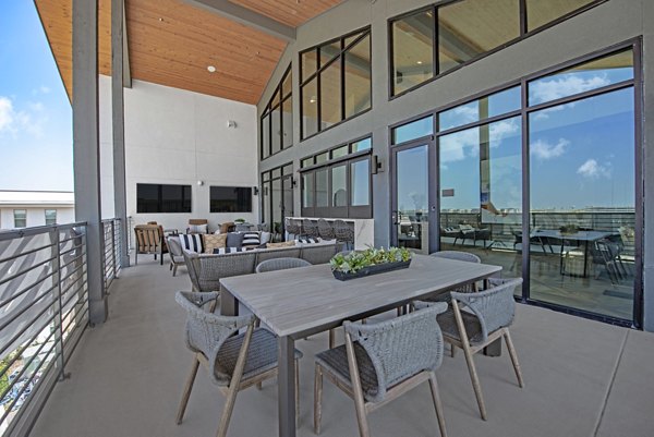 Clubhouse with modern seating and decor at Alta at the Farm Apartments
