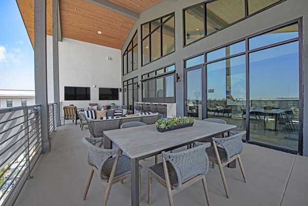 Modern clubhouse with luxurious seating and entertainment facilities at Alta at the Farm Apartments