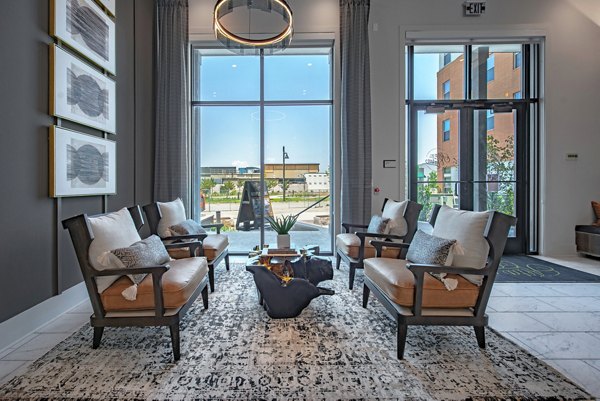 Clubhouse featuring modern decor and seating at Alta at the Farm Apartments