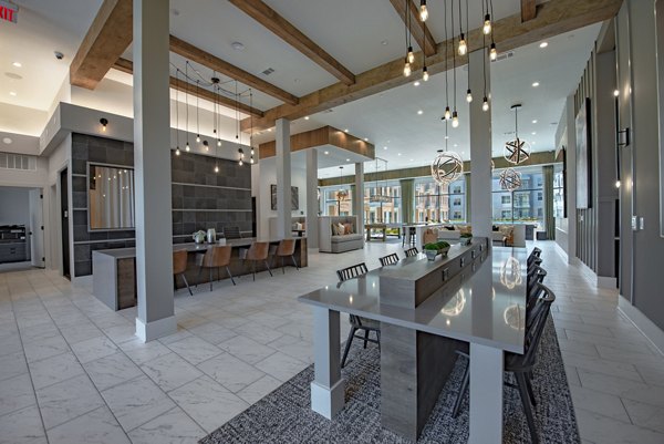 Modern clubhouse with comfortable seating and pool table at Alta at the Farm Apartments offering upscale community space for residents