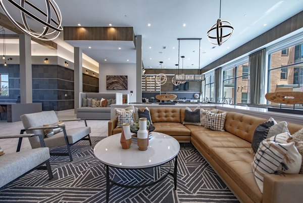 Modern clubhouse with lounge areas and pool table at Alta at the Farm Apartments
