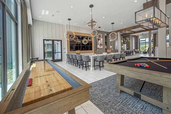 Modern clubhouse with lounge seating at Alta at the Farm Apartments, designed for social gatherings and relaxation in luxury living