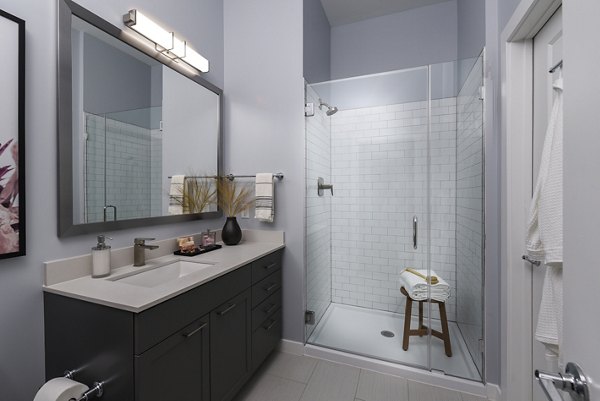 Alta Federal Hill Apartments: Modern bathroom with sleek fixtures and ample lighting in a luxury apartment