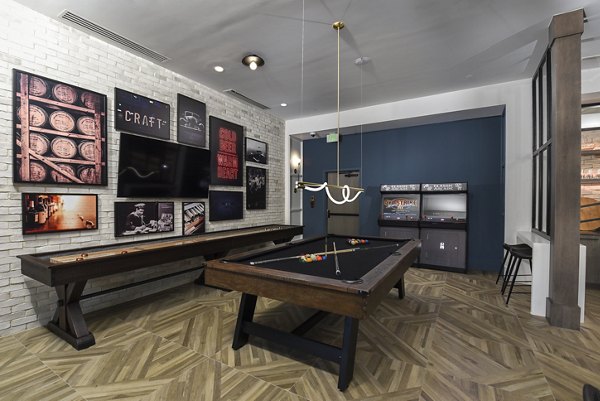 Game room featuring billiards table and lounge seating at Alta Federal Hill Apartments, offering a vibrant community space for relaxation and fun