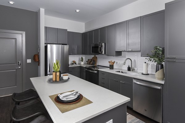 Modern kitchen with sleek appliances and granite countertops at Alta Federal Hill Apartments