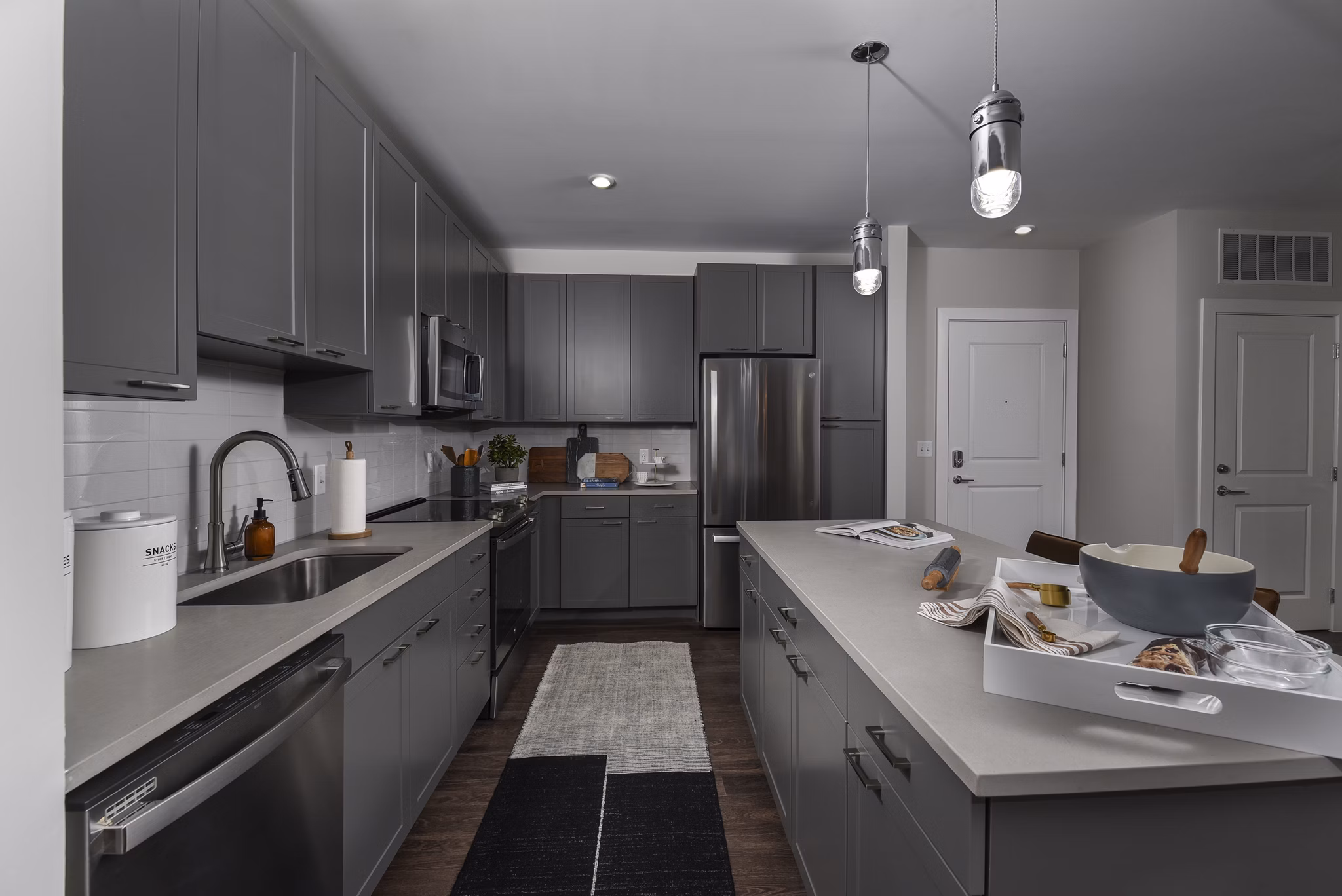 Modern kitchen with stainless steel appliances and granite countertops at Alta Federal Hill Apartments