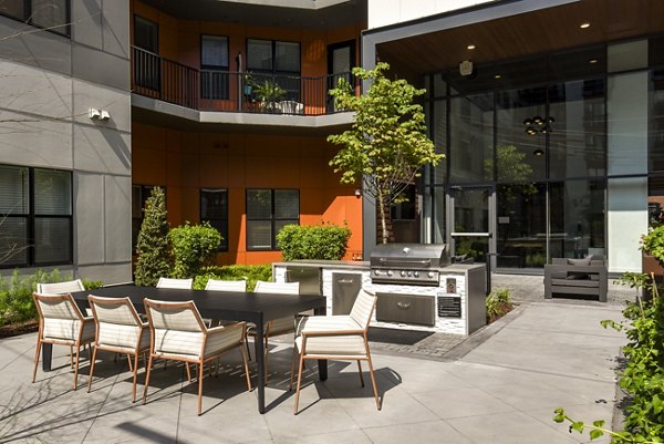 Rooftop grill area with modern seating at Alta Federal Hill Apartments offering city views