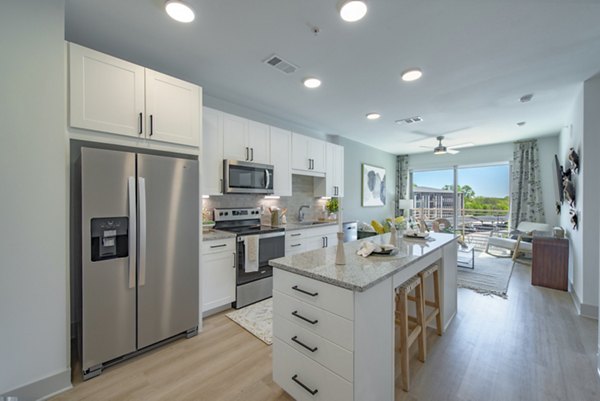 Modern kitchen with sleek appliances and granite countertops at Alta Firewheel Apartments